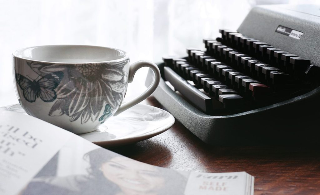 white-and-gray-floral-ceramic-cup-and-saucer-near-black-3047092